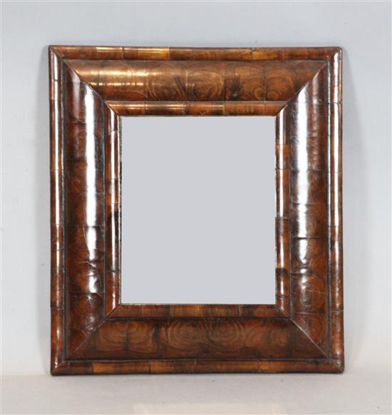 An early 18th century oyster veneered walnut cushion frame wall mirror, W.1ft 6.5in. H.1ft 9in.